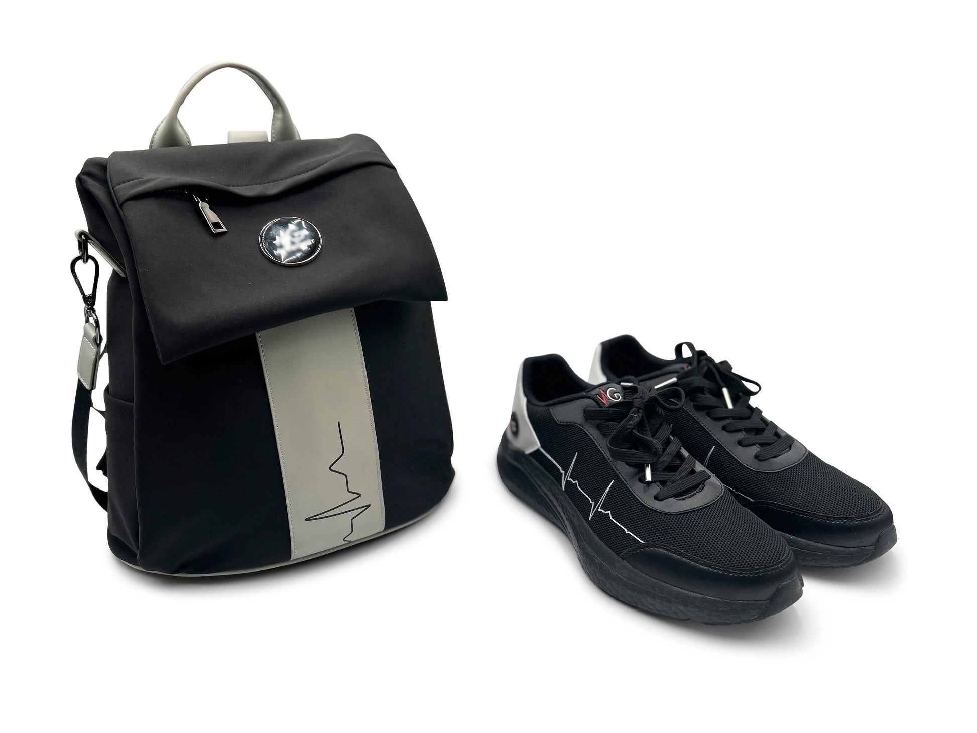 MoxieGalia Gidi-Up Lite black backpack with gray ECG stripe paired with StandFX 12 black sneakers — lifestyle-ready combo on white background.