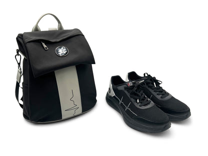 MoxieGalia Gidi-Up Lite black backpack with gray ECG stripe paired with StandFX 12 black sneakers — lifestyle-ready combo on white background.