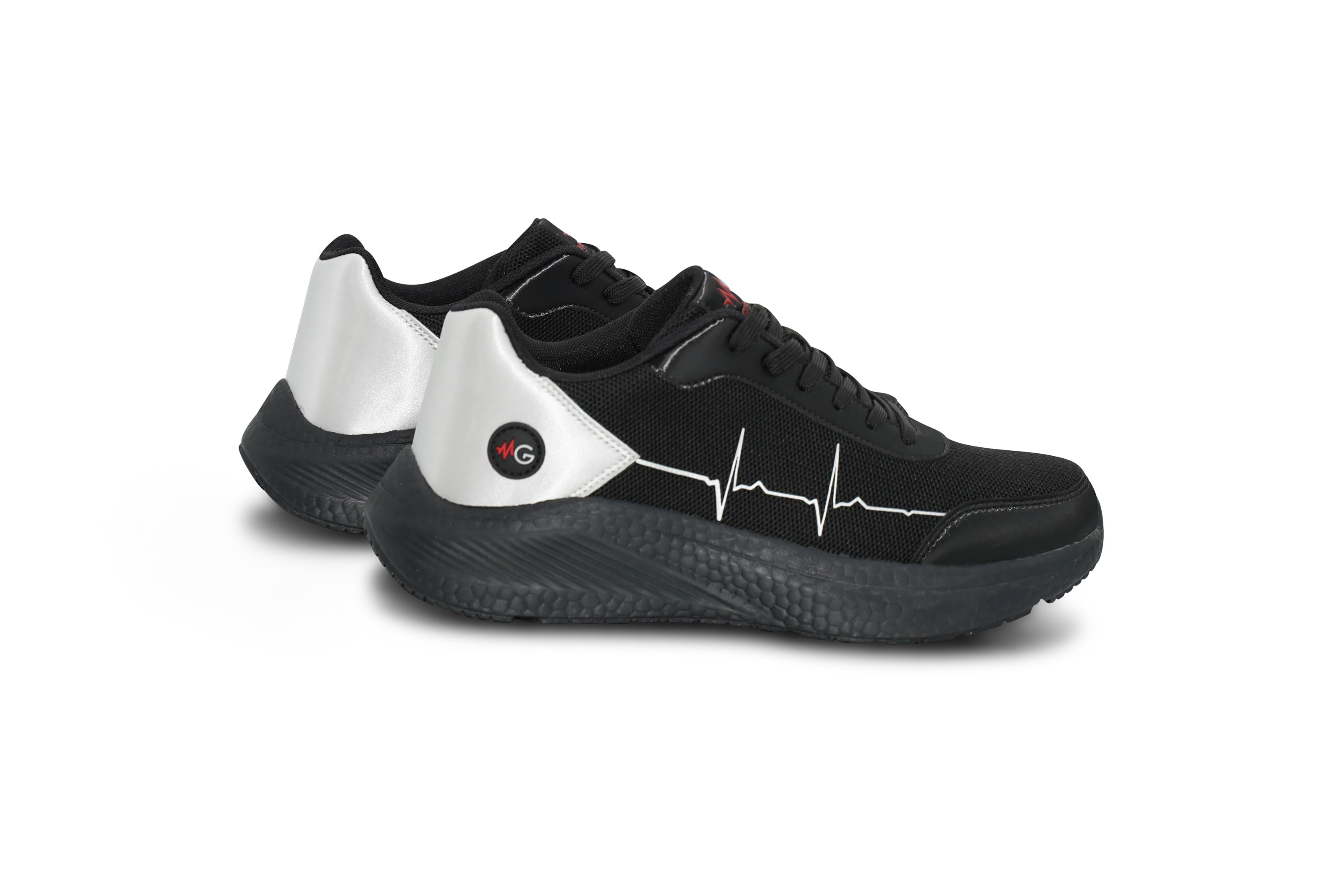 Flatlay of MoxieGalia StandFX 12 black and white sneakers with signature white ECG line across the side, black outsole, and red MG branding — displayed on white background.