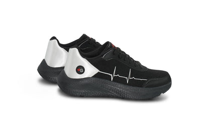 Flatlay of MoxieGalia StandFX 12 black and white sneakers with signature white ECG line across the side, black outsole, and red MG branding — displayed on white background.