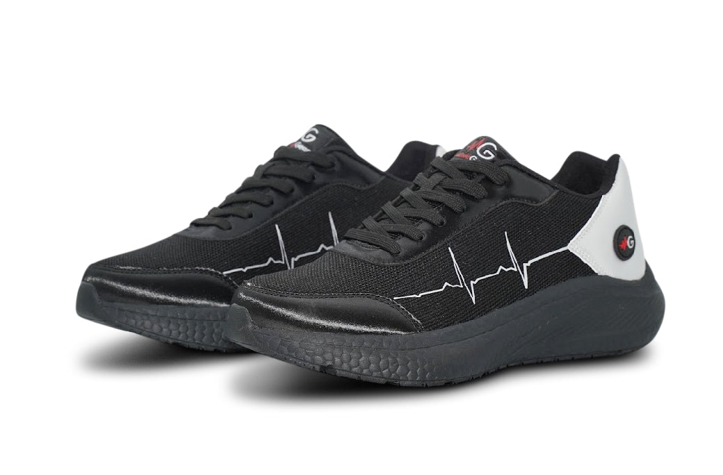 Front angle of MoxieGalia StandFX 12 sneakers in black and white featuring signature ECG side line, textured sole, and red MG logo — designed for all-day performance and bold visibility.

